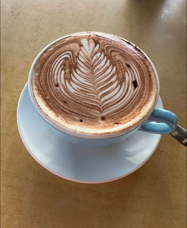 Roasting Warehouse specialty espresso with latte art — coffee at Harry's Cafe Laverton North
