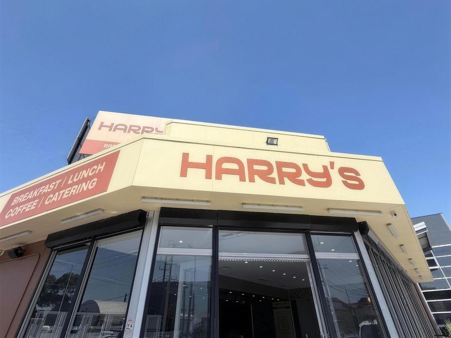 Harry's storefront on Dohertys Rd, with a sign reading Breakfast, Lunch, Coffee, Catering